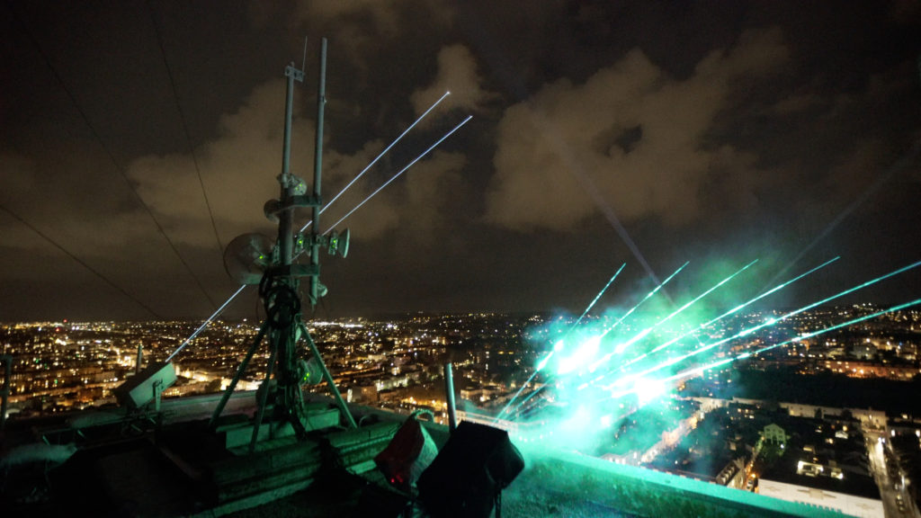 Lasers mounted on the top of Sussex Heights looking out to the Brighton skyline